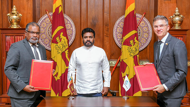 Secretary to the Treasury, Mahinda Siriwardana and David N. Sislen, World Bank Country Director for Sri Lanka sign an agreement under the oversight of Sri Lankan President Anura Kumara Dissanayake