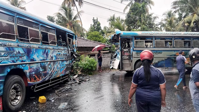 Damaged buses at the scene of a head-on collision in Talalla, Gandara, Sri Lanka