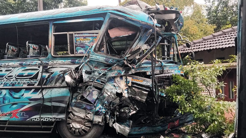 Damaged buses at the scene of a head-on collision in Talalla, Gandara, Sri Lanka