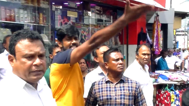 People inspecting a mini lorry damaged by firecrackers after the Moratuwa Cooperative election celebration