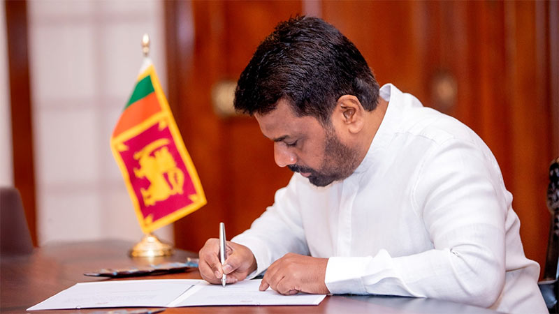 Sri Lankan President Anura Kumara Dissanayake signing an official document at the Presidential Secretariat