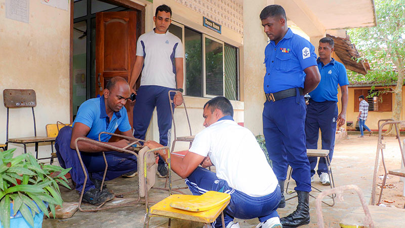 Sri Lanka Navy personnel repairing a school chair during the Clean Sri Lanka initiative